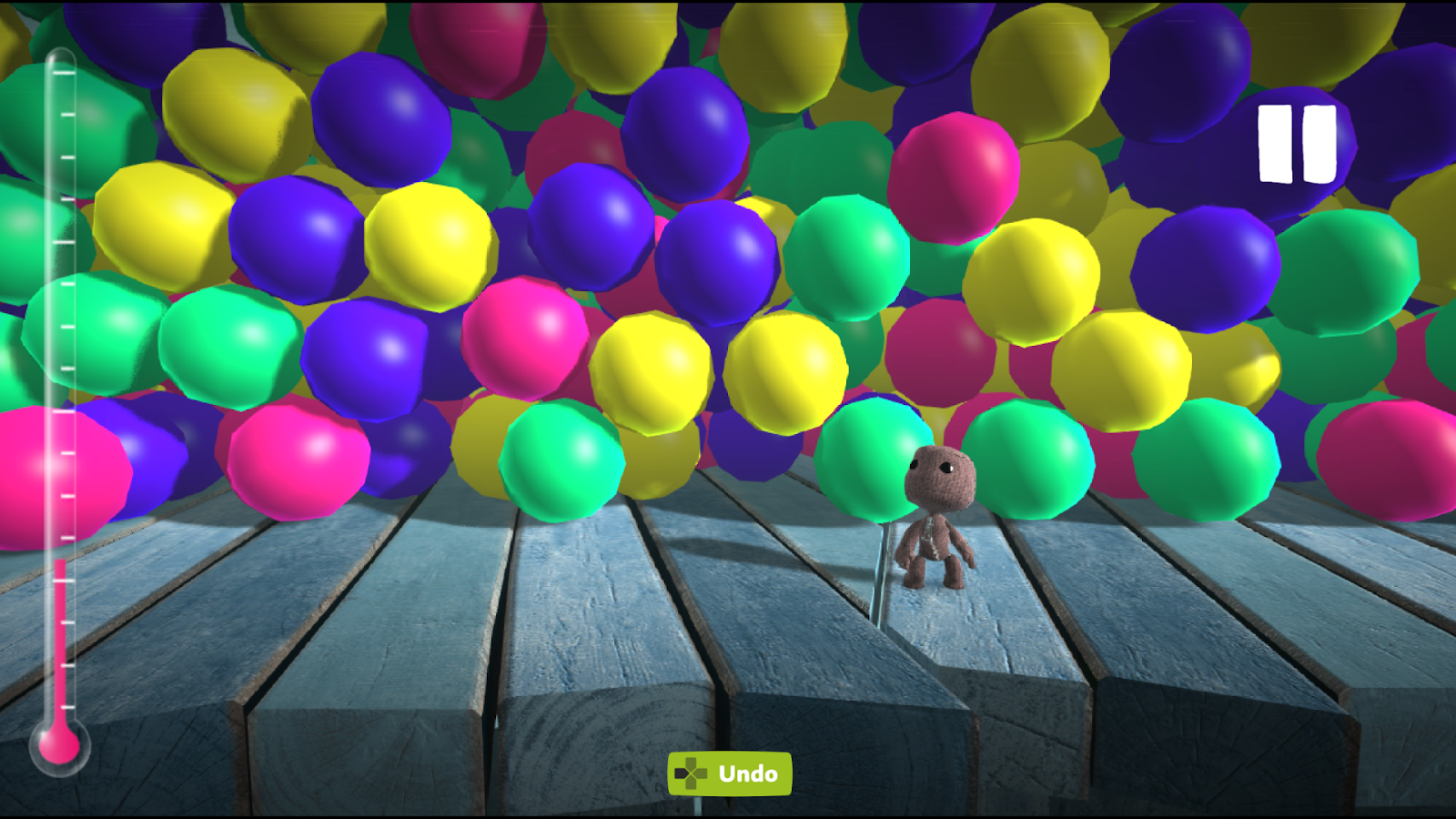 Sackboy is accompanied by a ton of different colored balls. The thermometer is red and not very full, indicating that this level is not using dynamic thermometer.